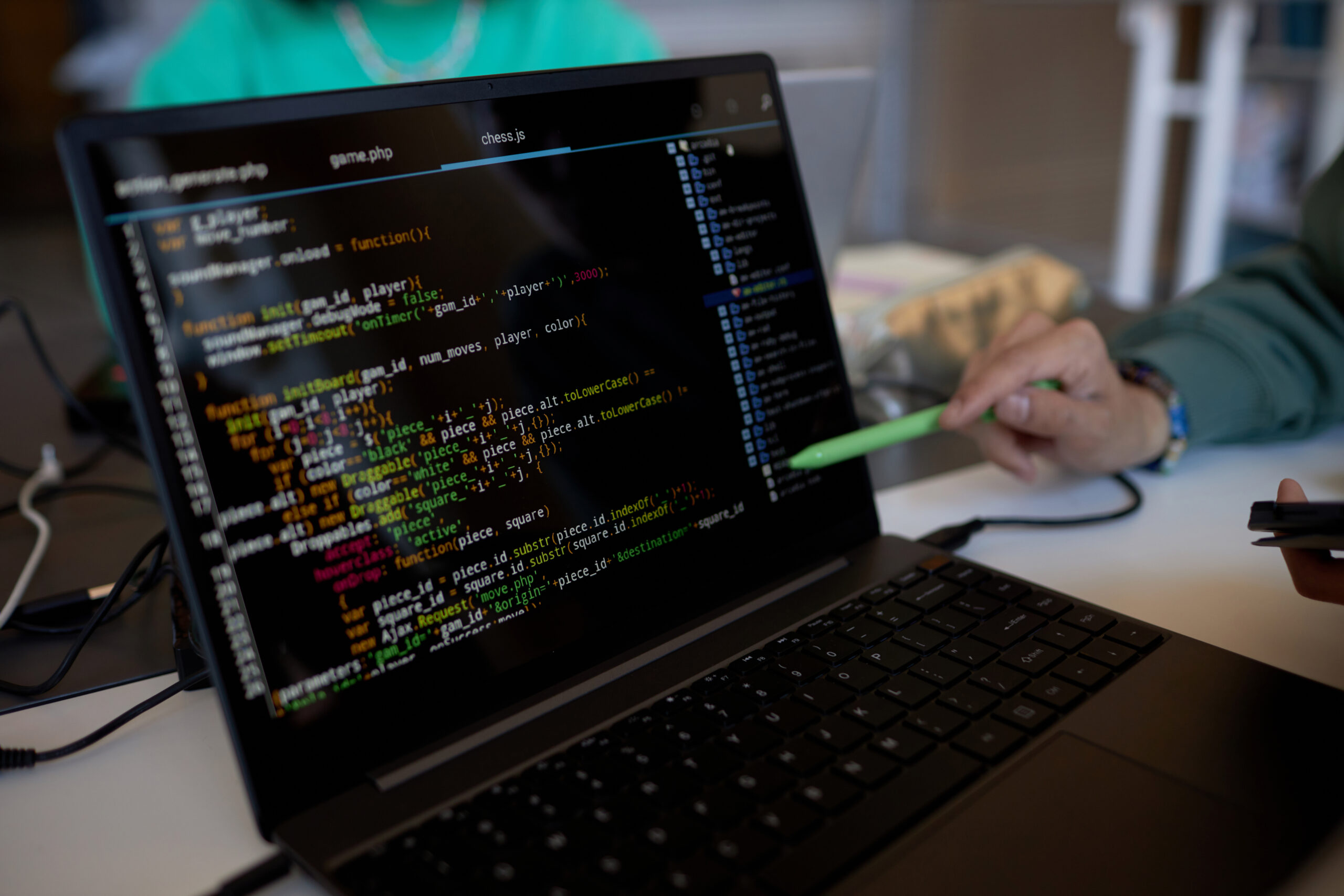 focus-on-laptop-screen-with-coded-data-and-pen-hel-2025-02-11-15-42-45-utc-scaled.jpg
